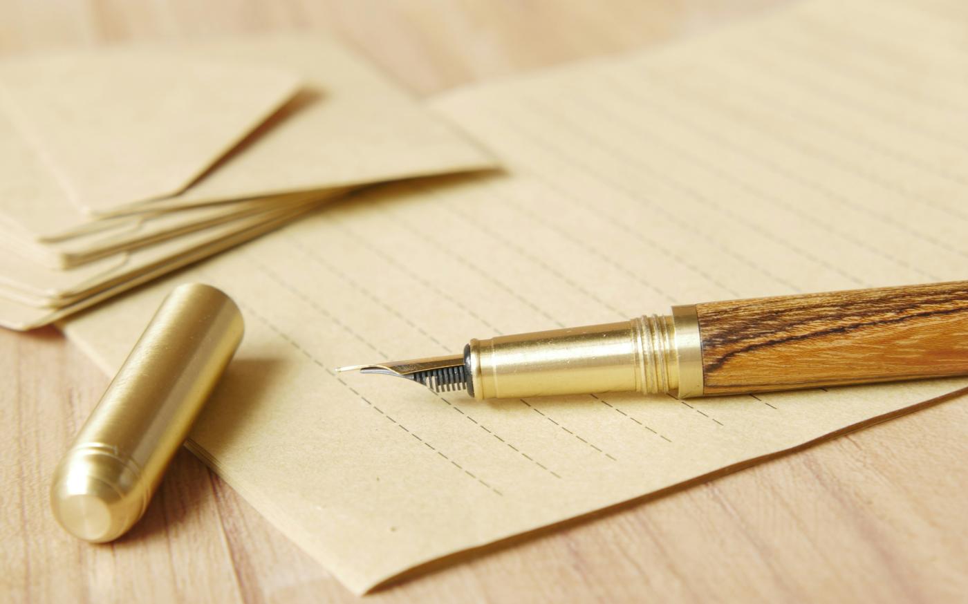 a pen and some papers on a table by Towfiqu barbhuiya courtesy of Unsplash.
