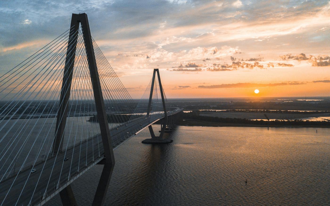 cable-stayed bridge view during golden hour by David Martin courtesy of Unsplash.