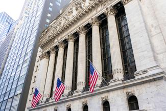New york stock exchange building with american flags by Maxim Klimashin courtesy of Unsplash.