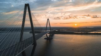 cable-stayed bridge view during golden hour by David Martin courtesy of Unsplash.