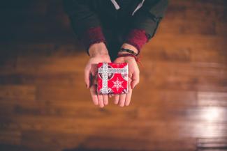 person holding red and white box by Ben White courtesy of Unsplash.