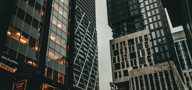 a group of tall buildings next to each other by Jonathan Gong courtesy of Unsplash.
