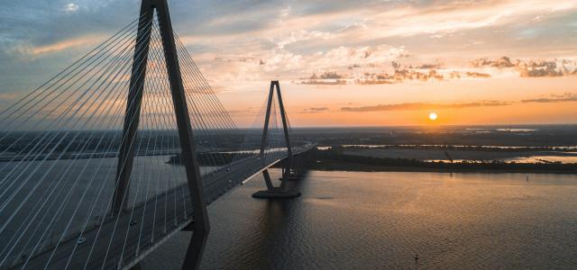 cable-stayed bridge view during golden hour by David Martin courtesy of Unsplash.